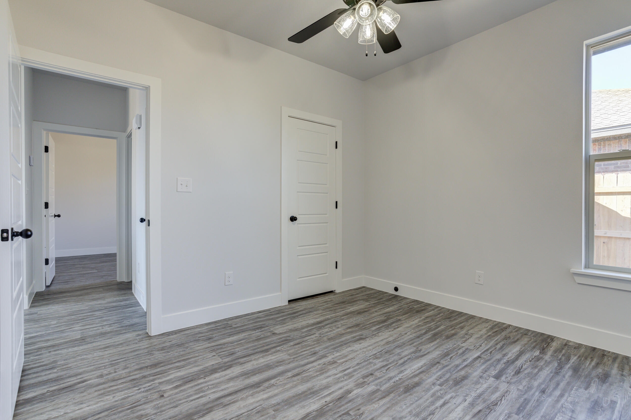 6926 12th Street Lubbock, TX 79416 - Photo 34 of 39 an empty room with wooden floor and windows