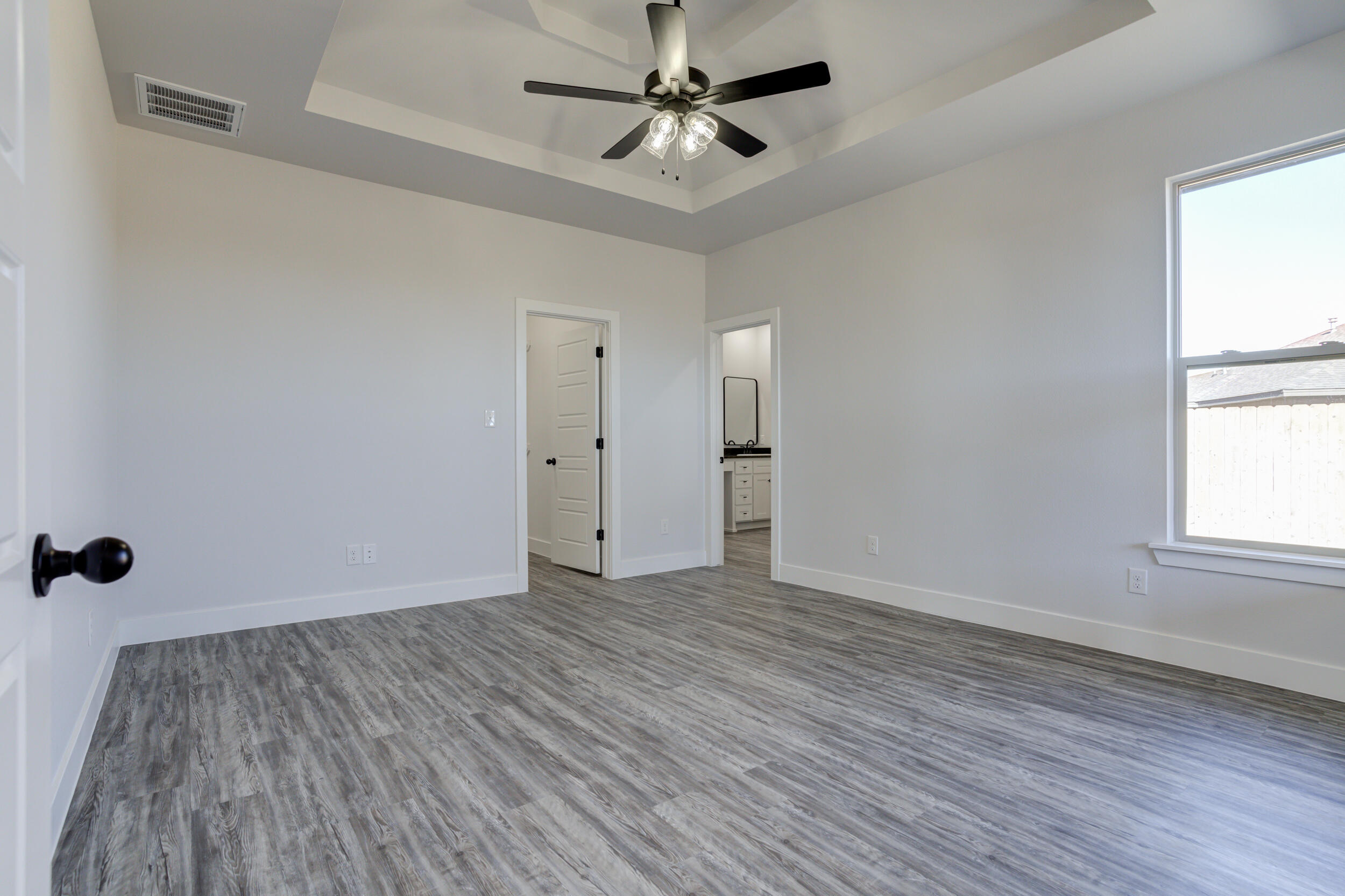 6926 12th Street Lubbock, TX 79416 - Photo 35 of 39 wooden floor in an empty room with a window