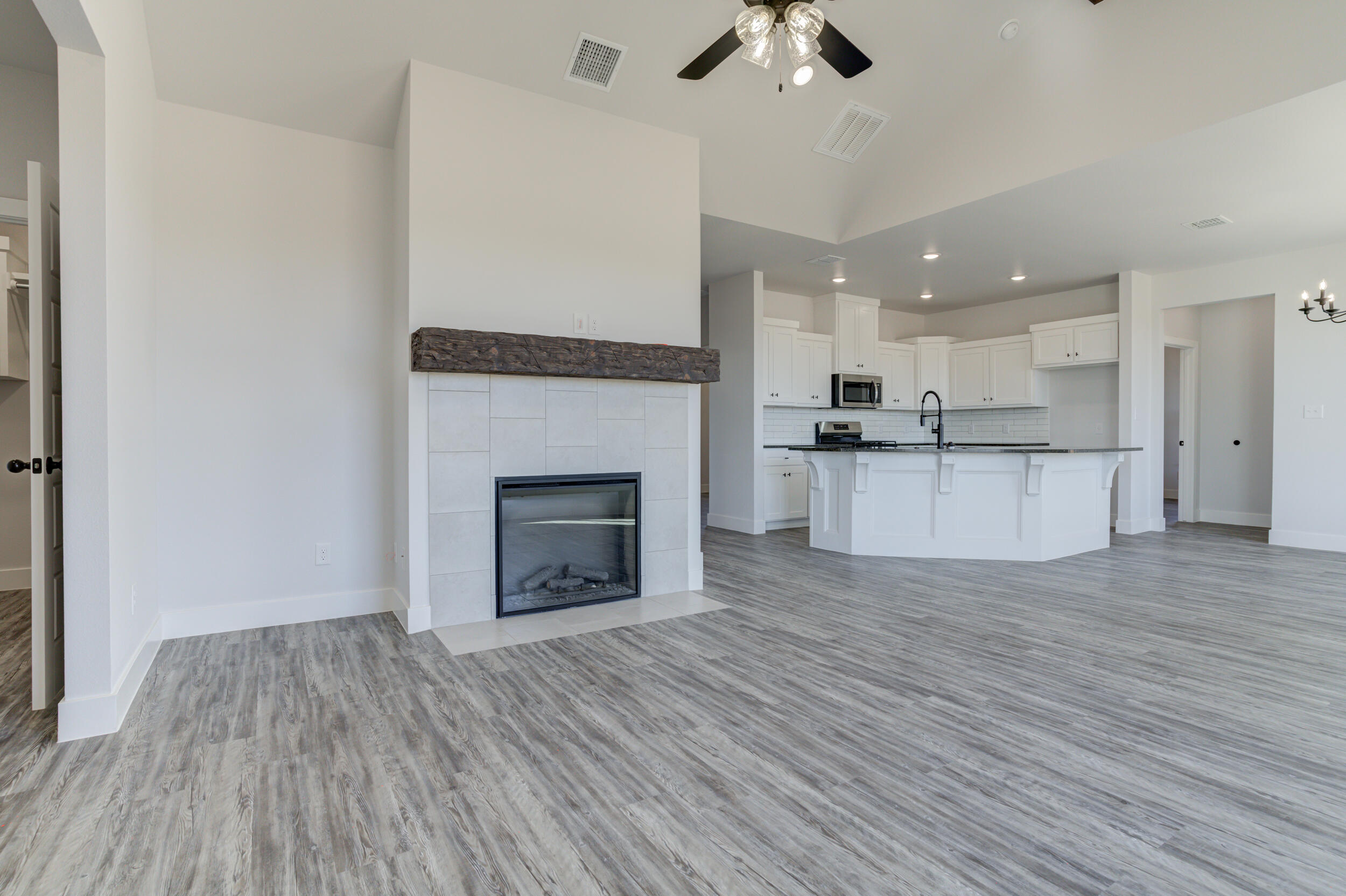6926 12th Street Lubbock, TX 79416 - Photo 7 of 39 a view of a kitchen with a dishwasher and a fireplace
