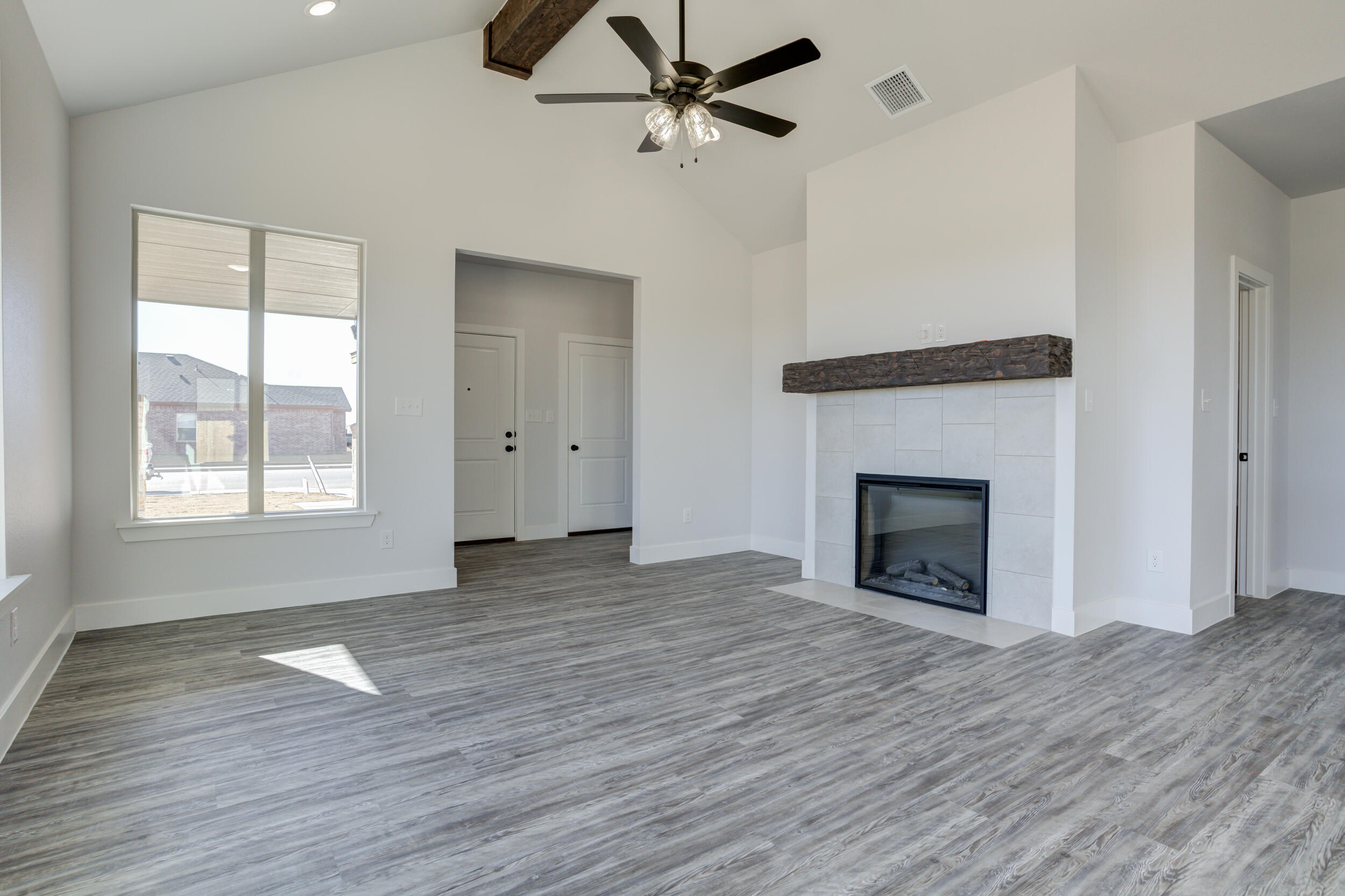 6926 12th Street Lubbock, TX 79416 - Photo 9 of 39 a view of empty room with wooden floor and fan