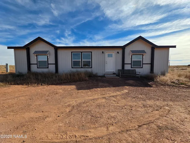 a house view with a backyard space