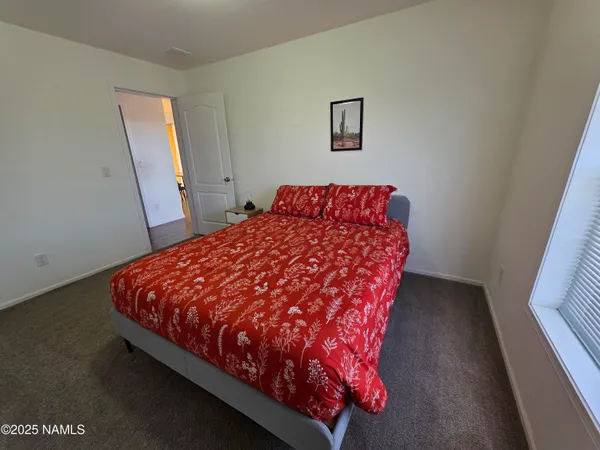 a bed sitting in a bedroom next to a window