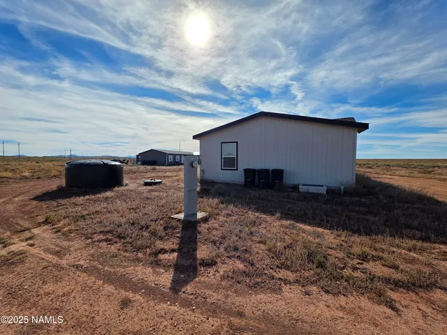 a view of house with backyard space