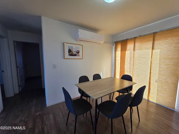 a view of a dining room with furniture window and wooden floor