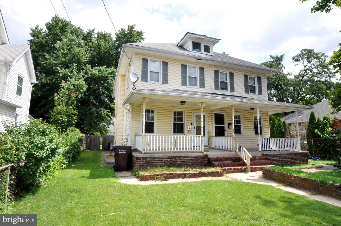 425 Delaware Avenue Riverside, NJ 08075 - Photo 1 of 33 a front view of a house with a yard table and chairs