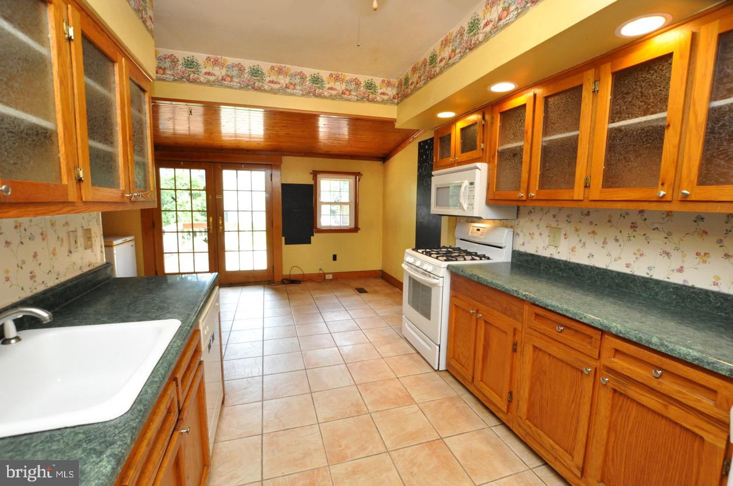 425 Delaware Avenue Riverside, NJ 08075 - Photo 12 of 33 a kitchen with stainless steel appliances granite countertop a sink and cabinets
