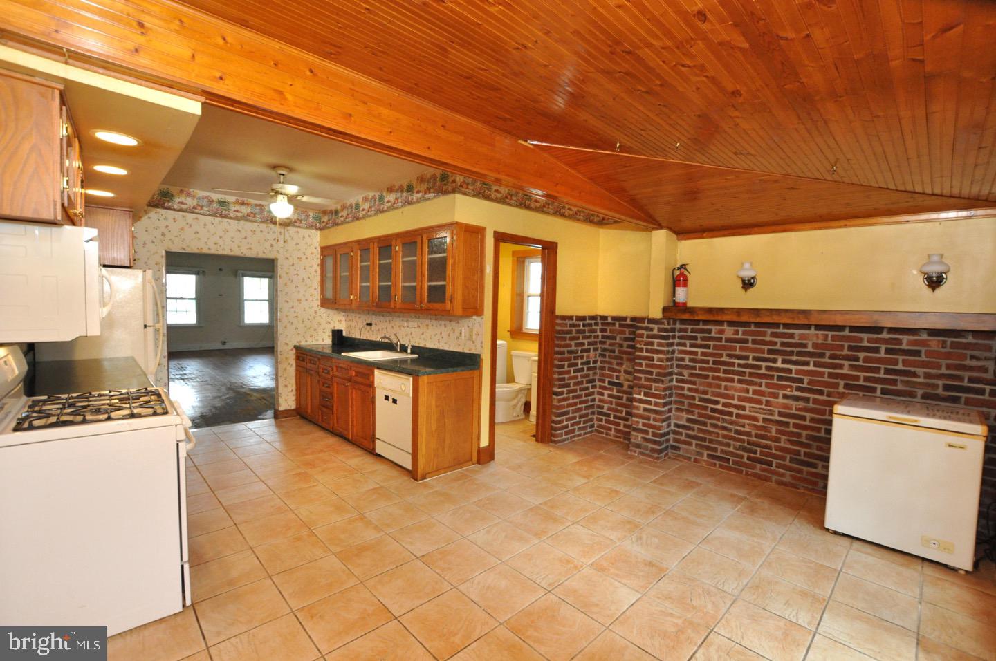 425 Delaware Avenue Riverside, NJ 08075 - Photo 15 of 33 a kitchen with stainless steel appliances kitchen island granite countertop a stove a sink and a microwave