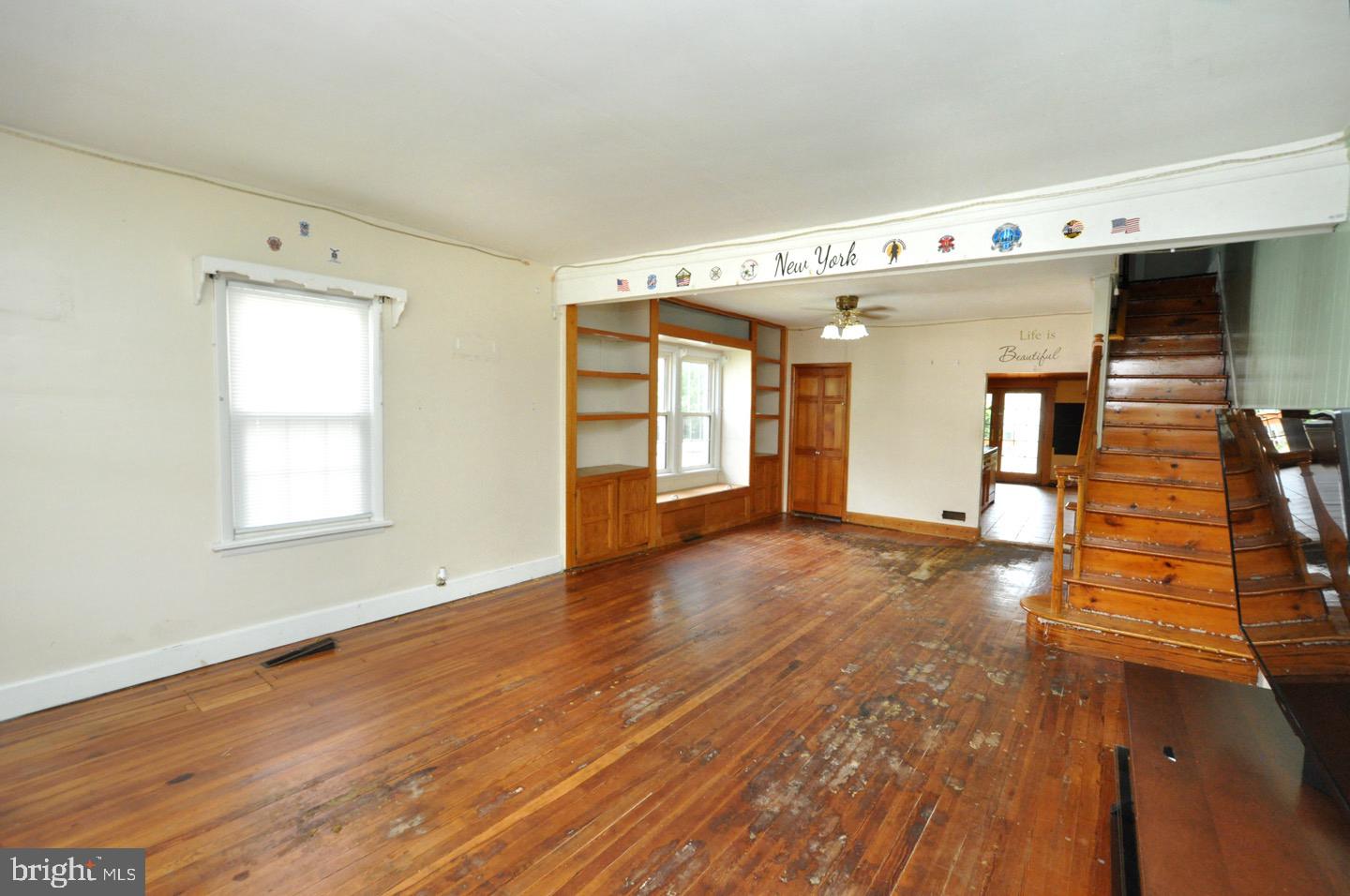 425 Delaware Avenue Riverside, NJ 08075 - Photo 5 of 33 a view of an empty room with window and wooden floor