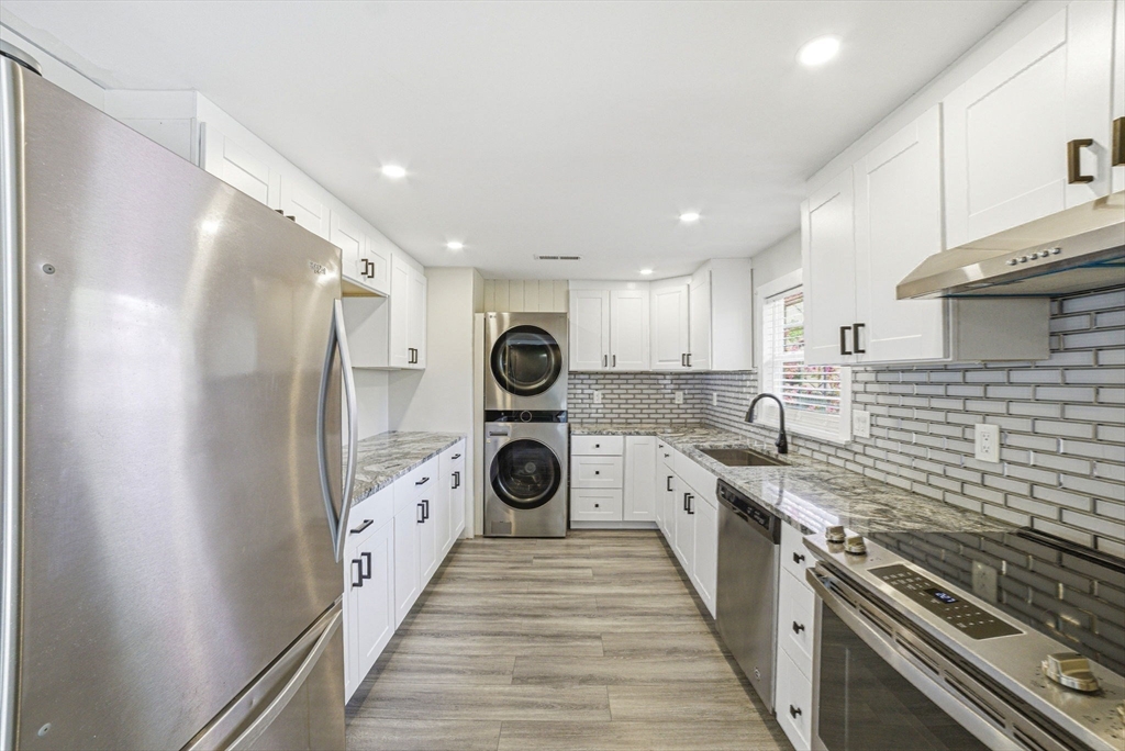 157 Errol Road Brockton, MA 02302 - Photo 17 of 34 a kitchen with a sink a stove and refrigerator