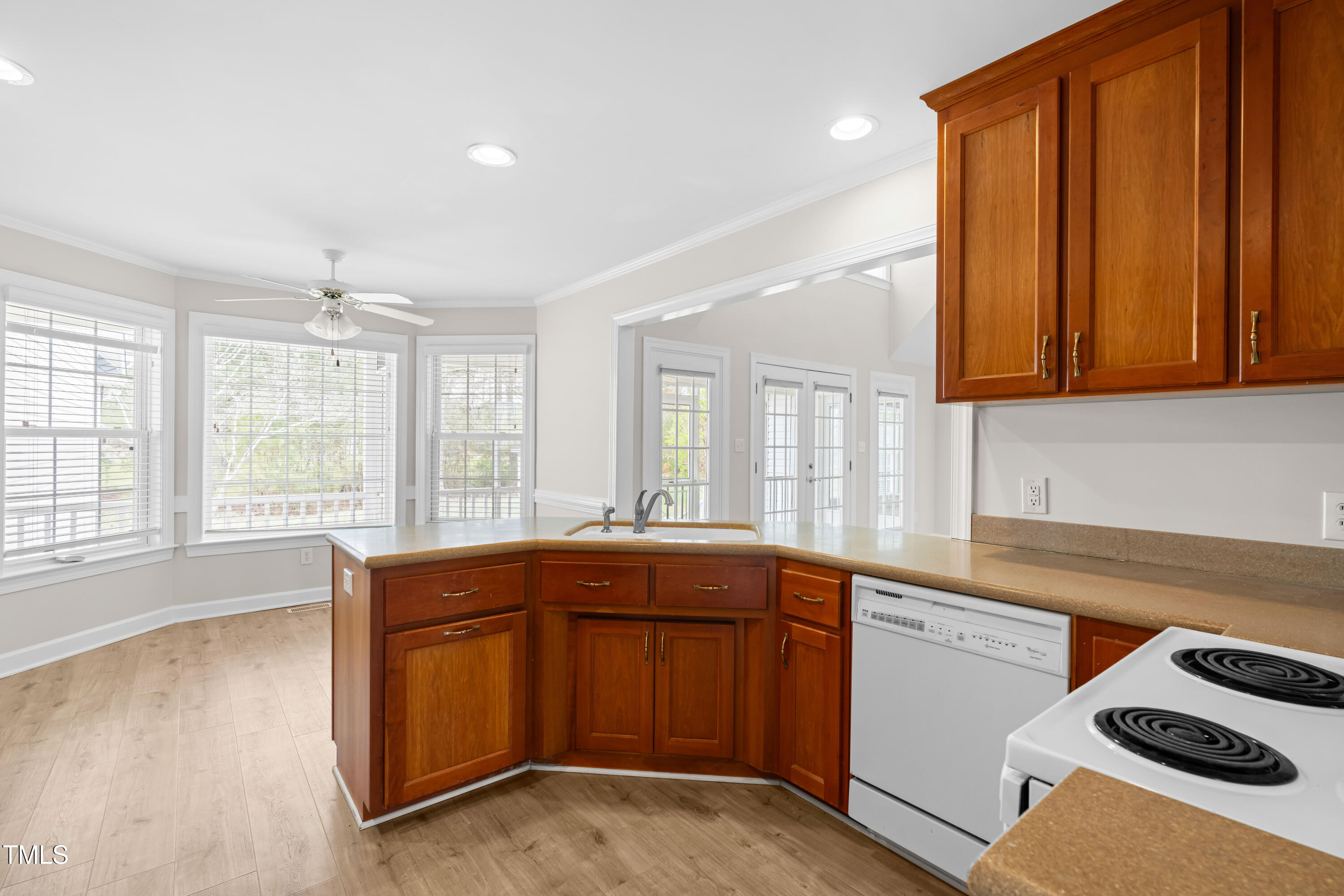 44 Loop Road Archer Lodge, NC 27527 - Photo 12 of 48 a kitchen with a sink and wooden cabinets