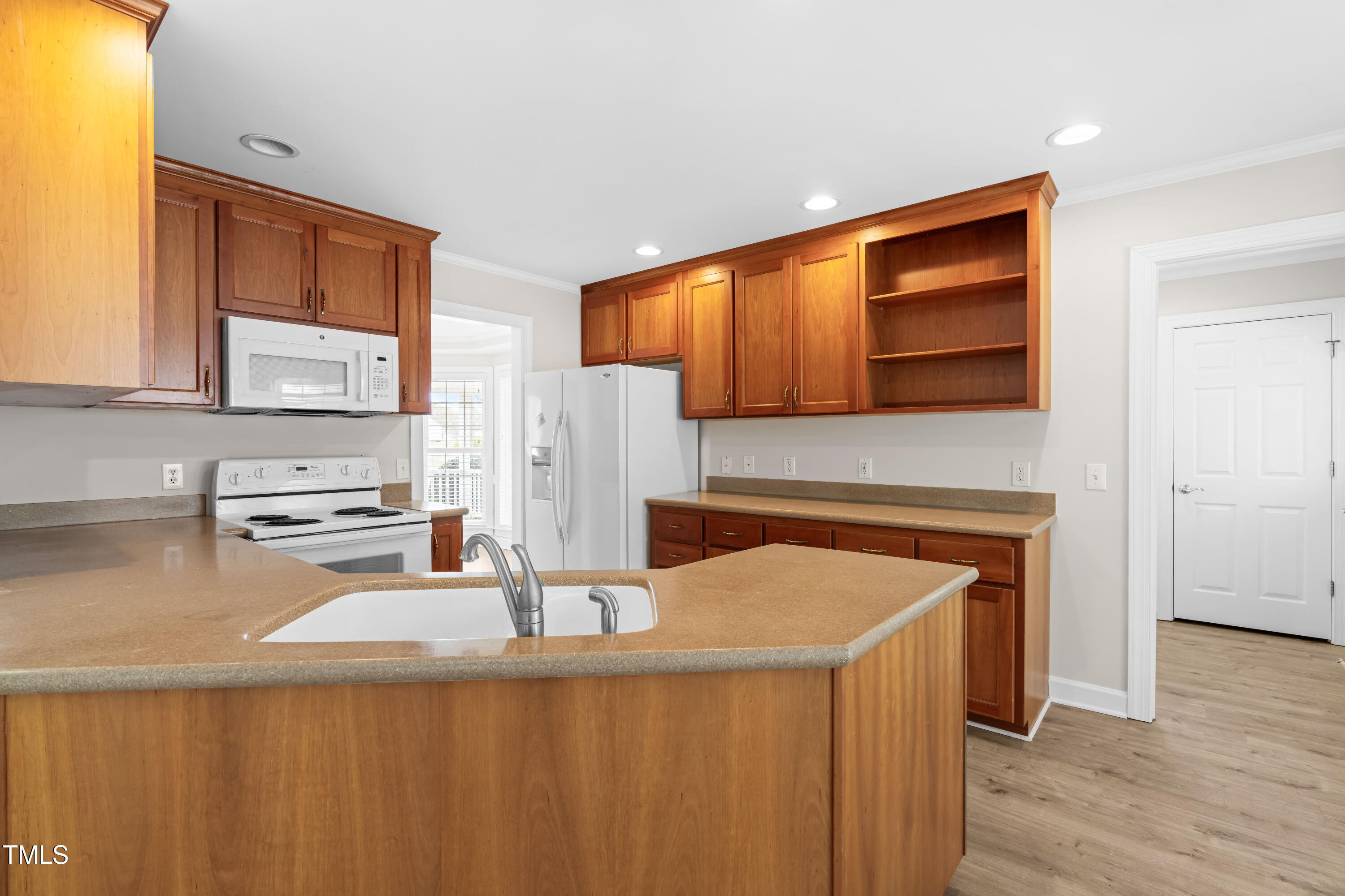 44 Loop Road Archer Lodge, NC 27527 - Photo 13 of 48 a kitchen with stainless steel appliances granite countertop a sink stove and refrigerator