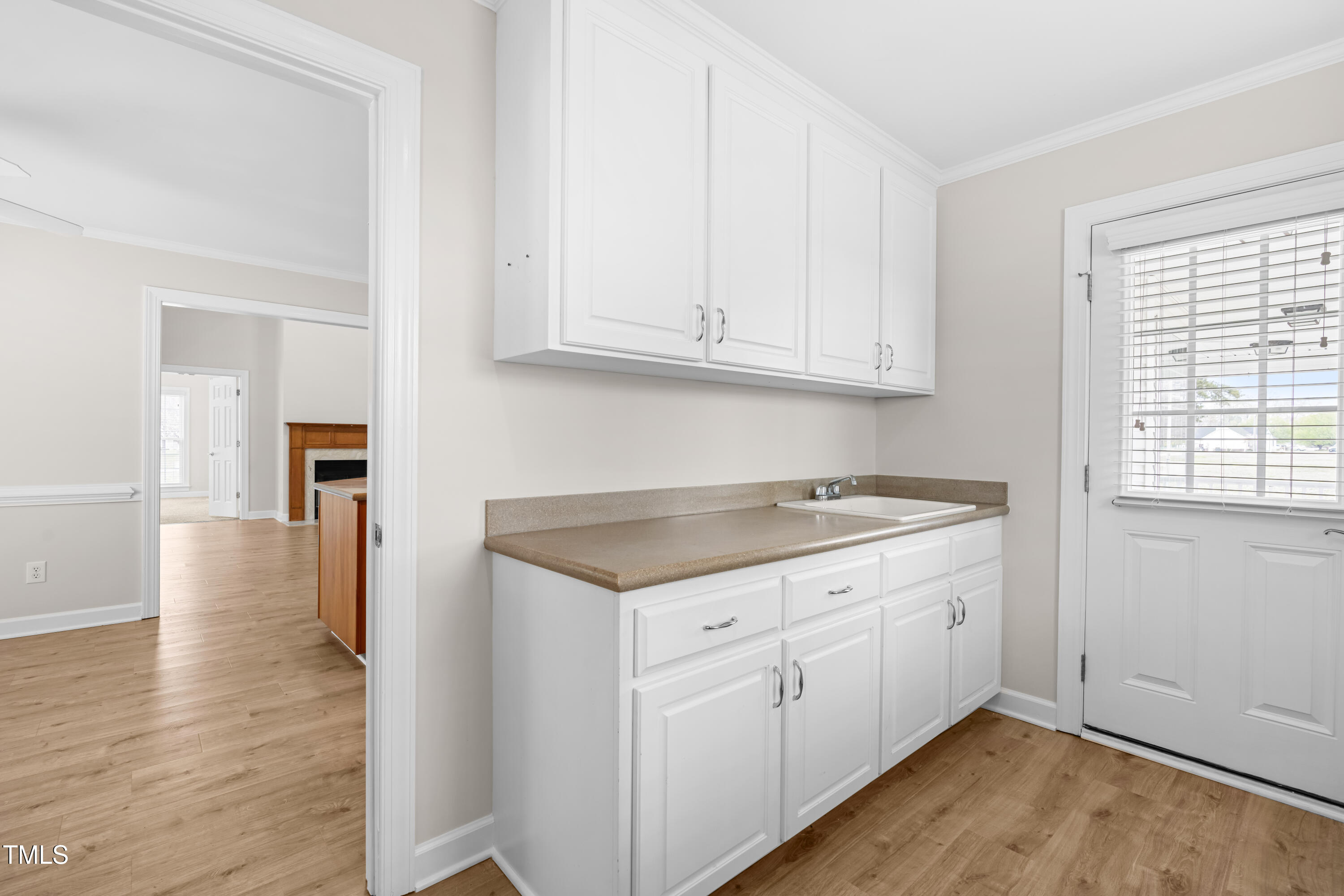 44 Loop Road Archer Lodge, NC 27527 - Photo 14 of 48 an empty room with wooden floor and cabinet