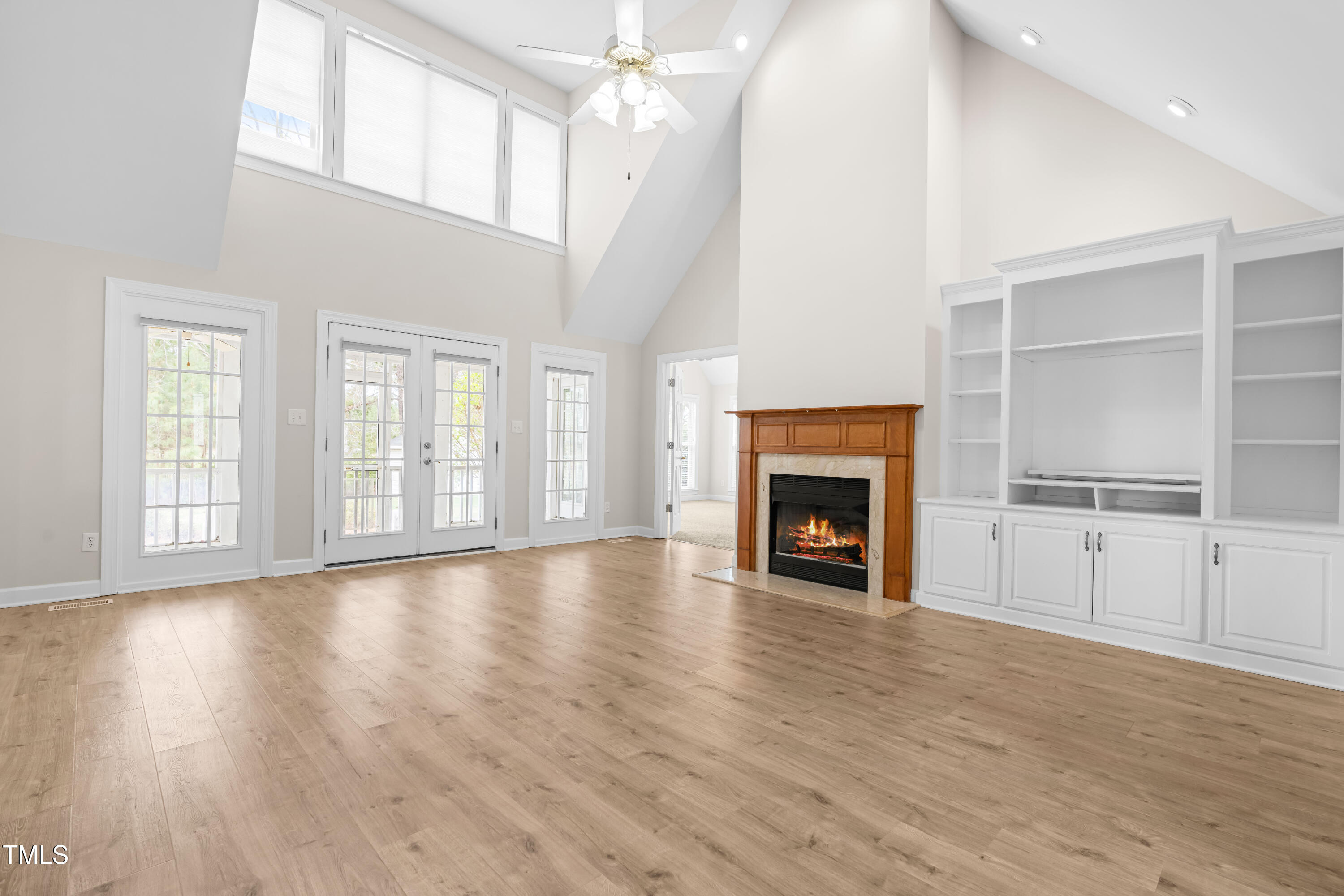 44 Loop Road Archer Lodge, NC 27527 - Photo 19 of 48 a view of an empty room with wooden floor fireplace and a window