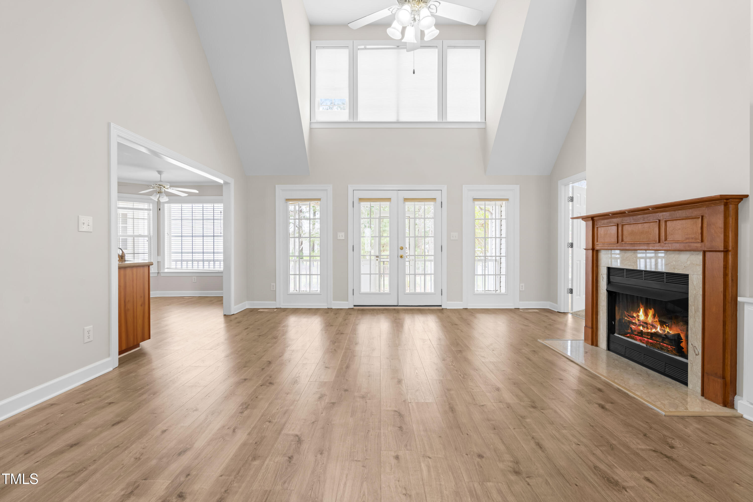 44 Loop Road Archer Lodge, NC 27527 - Photo 20 of 48 an empty room with wooden floor fireplace and windows