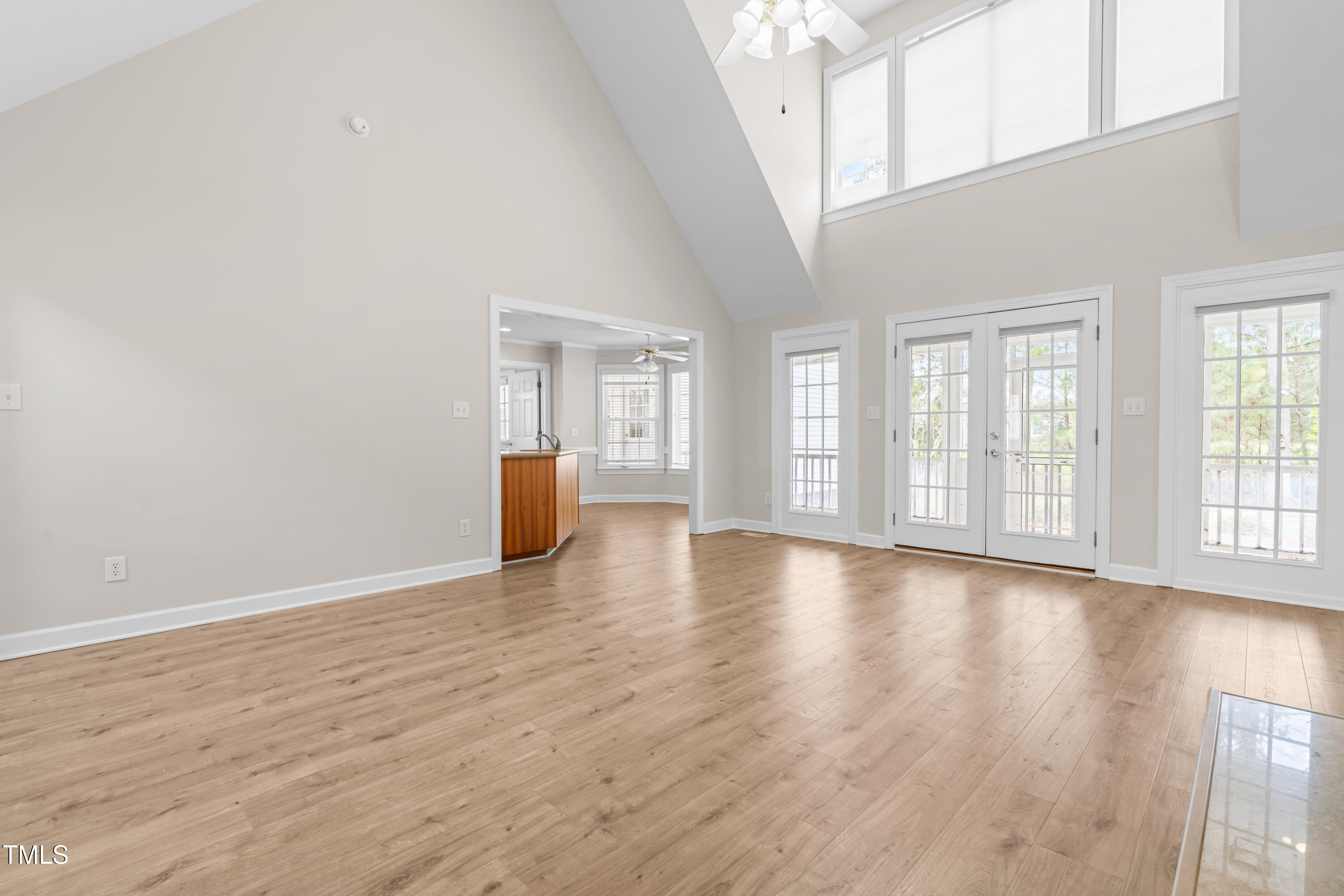 44 Loop Road Archer Lodge, NC 27527 - Photo 21 of 48 a view of an empty room with wooden floor and a window