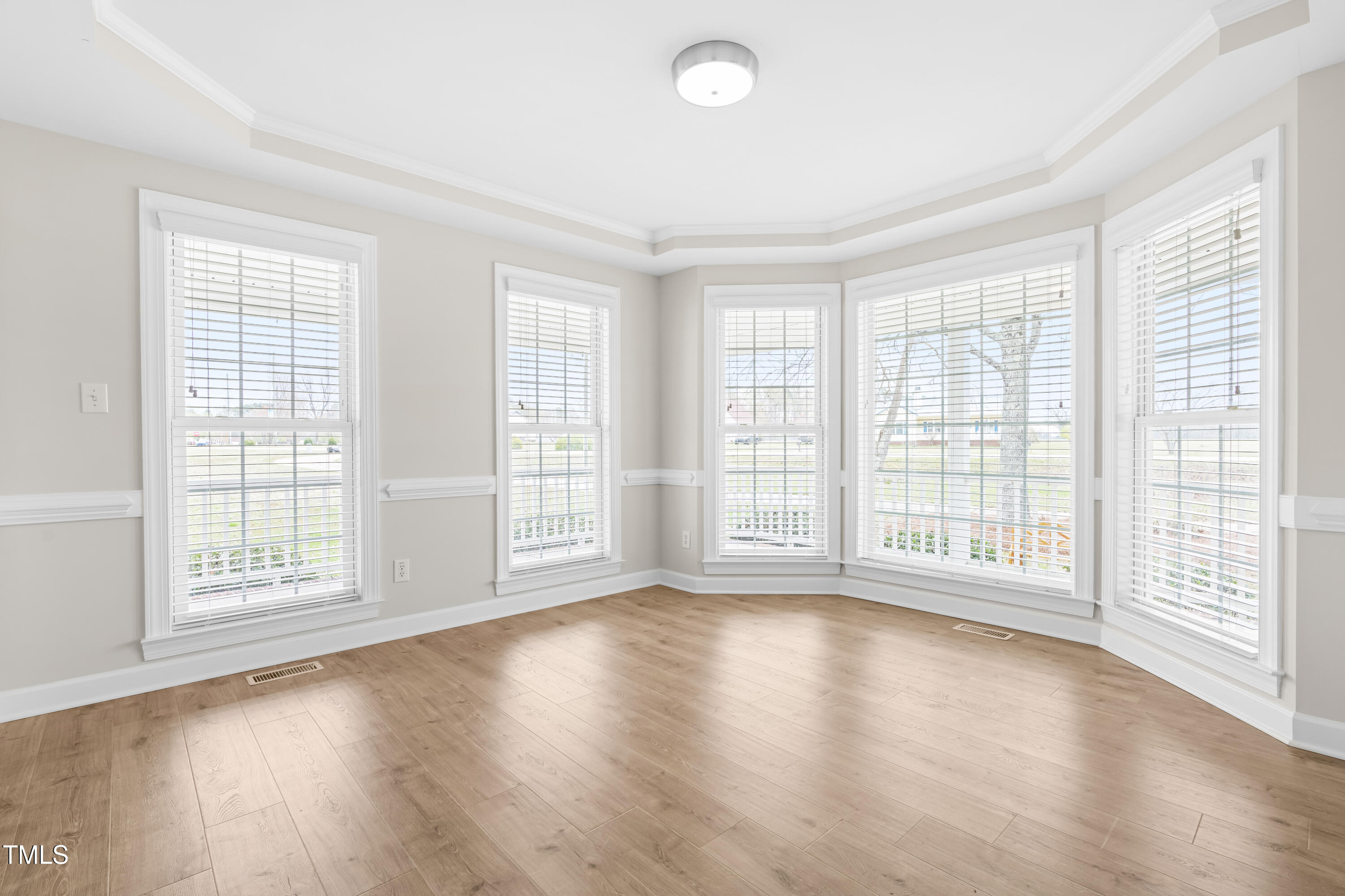 44 Loop Road Archer Lodge, NC 27527 - Photo 22 of 48 a view of an empty room with wooden floor and a window