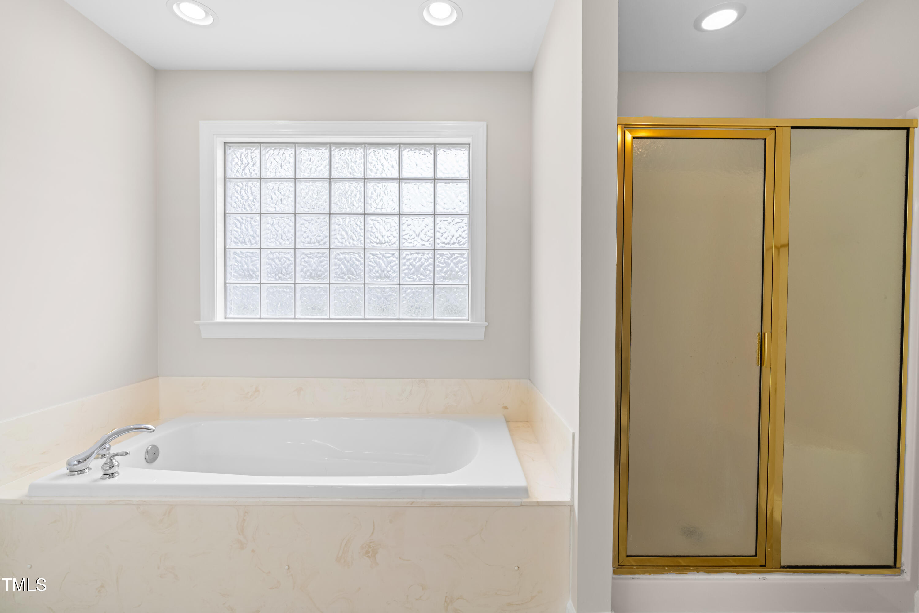 44 Loop Road Archer Lodge, NC 27527 - Photo 26 of 48 a white bath tub sitting next to a window