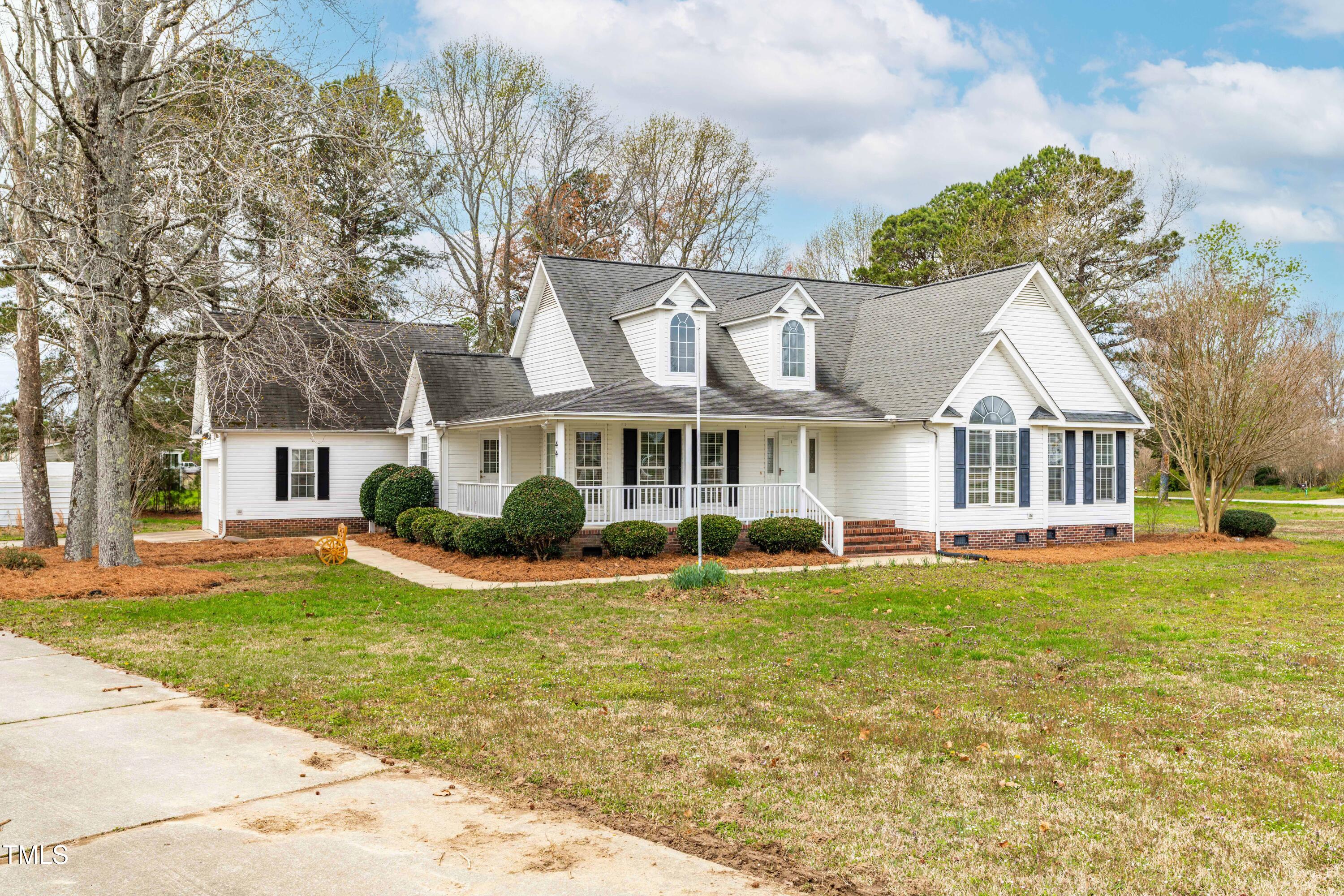 44 Loop Road Archer Lodge, NC 27527 - Photo 3 of 48 a front view of a house with a yard table and chairs