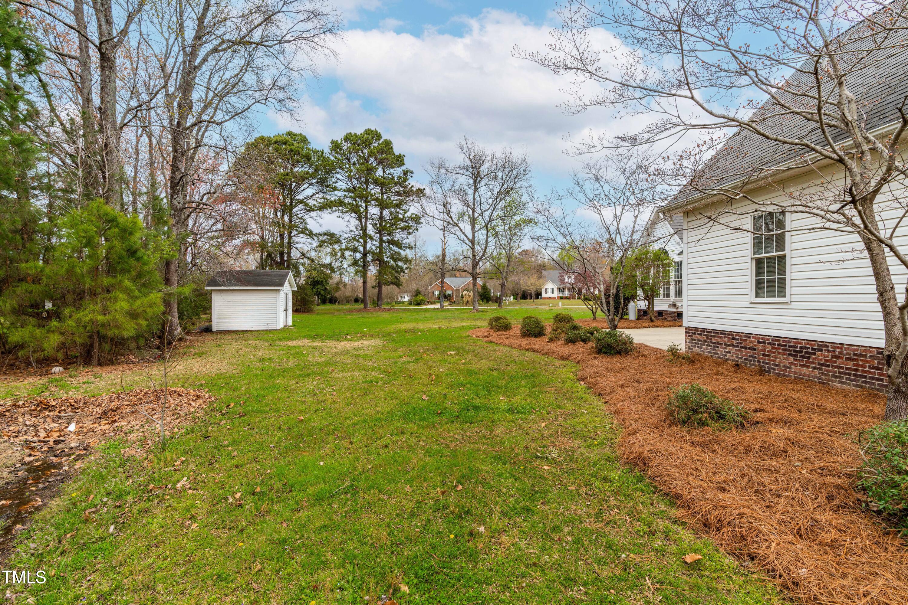 44 Loop Road Archer Lodge, NC 27527 - Photo 31 of 48 a yellow and red house sitting in the middle of a yard