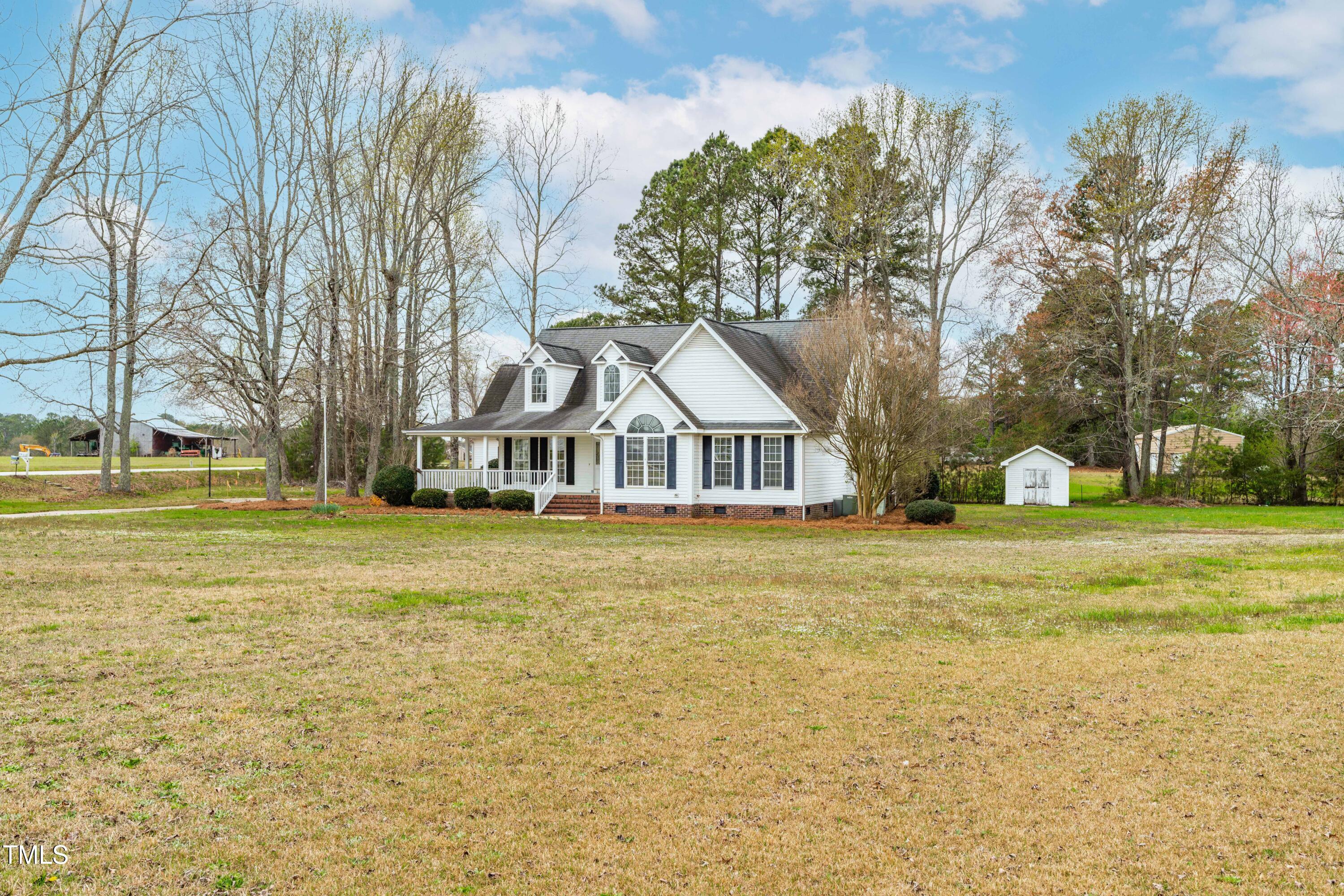 44 Loop Road Archer Lodge, NC 27527 - Photo 4 of 48 a front view of a house with a yard and trees