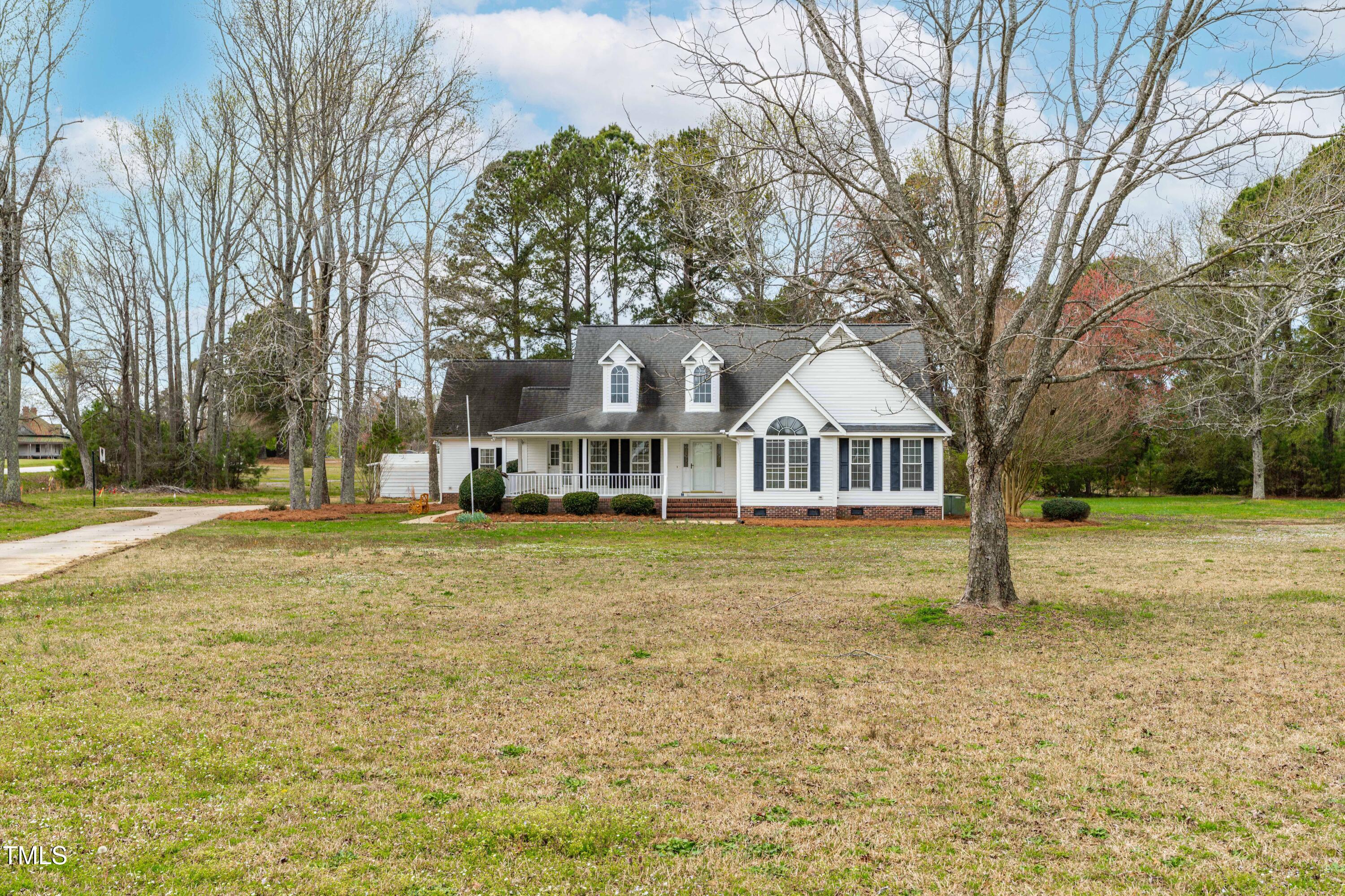 44 Loop Road Archer Lodge, NC 27527 - Photo 6 of 48 a front view of a house with a garden