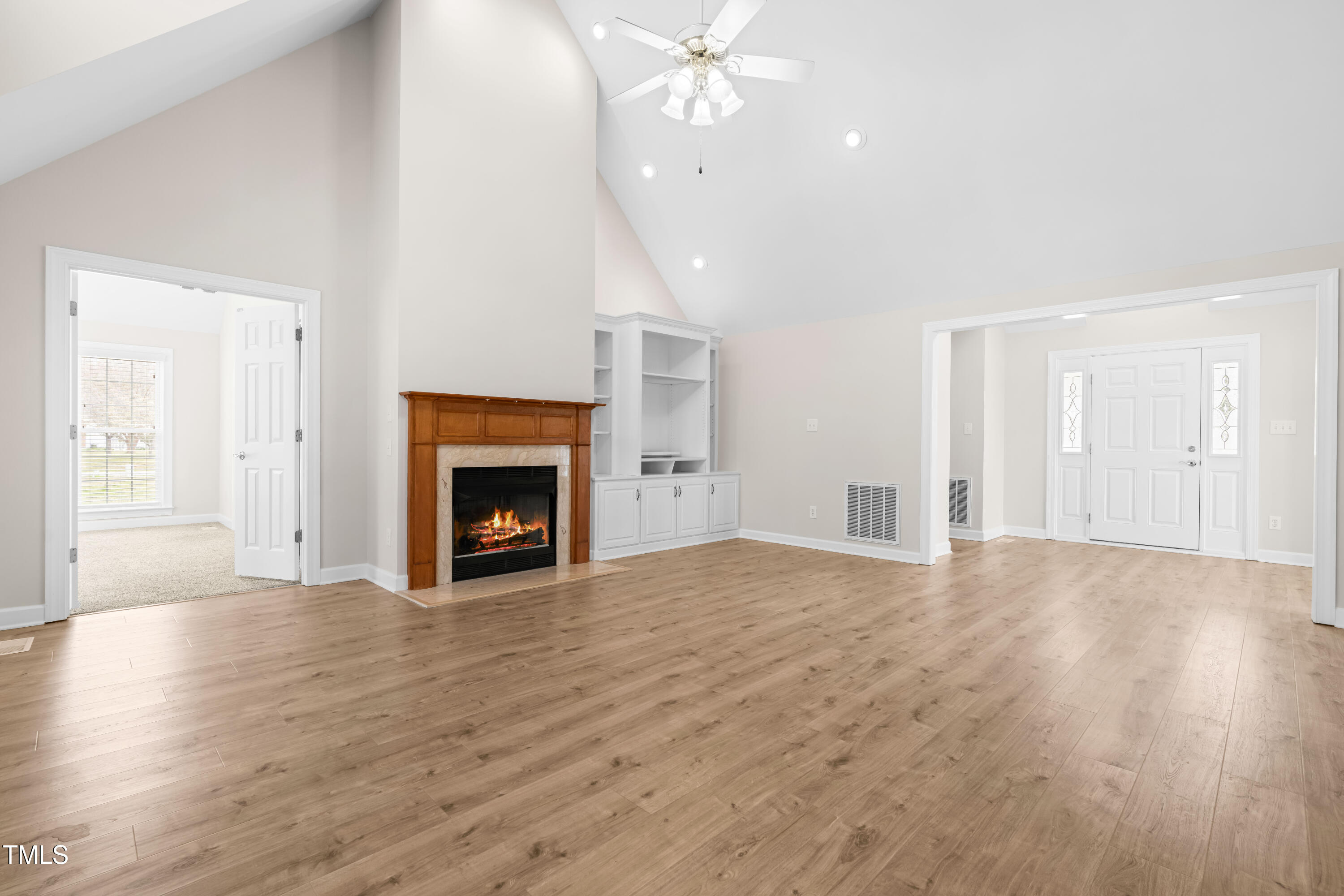 44 Loop Road Archer Lodge, NC 27527 - Photo 9 of 48 a view of an empty room with wooden floor fireplace and a window