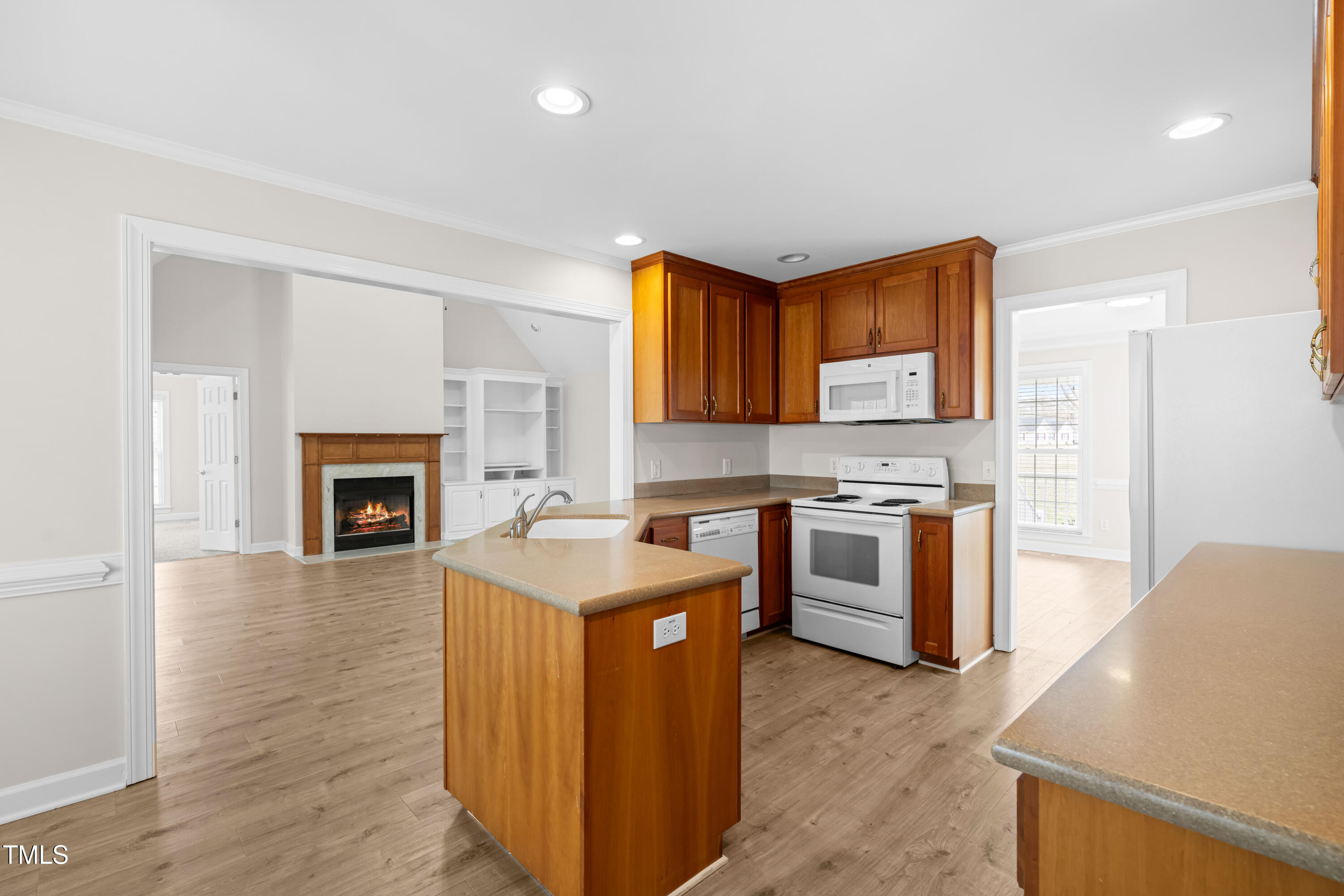 44 Loop Road Archer Lodge, NC 27527 - Photo 10 of 48 a kitchen with stainless steel appliances granite countertop a stove top oven a sink dishwasher and a refrigerator with wooden floor