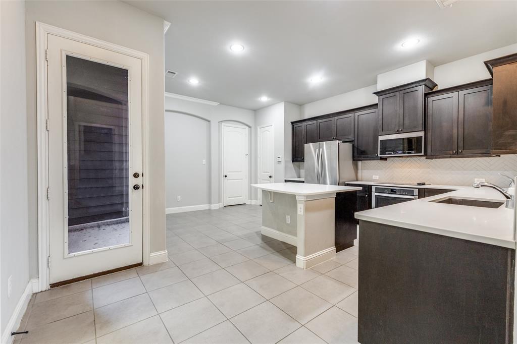 828 Rohan Drive Richardson, TX 75081 - Photo 11 of 25 a kitchen with sink cabinets and stainless steel appliances