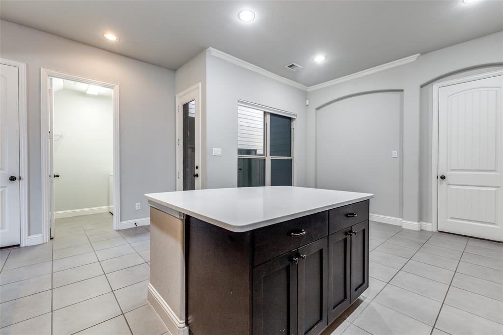 828 Rohan Drive Richardson, TX 75081 - Photo 12 of 25 a kitchen with a sink a refrigerator and cabinets