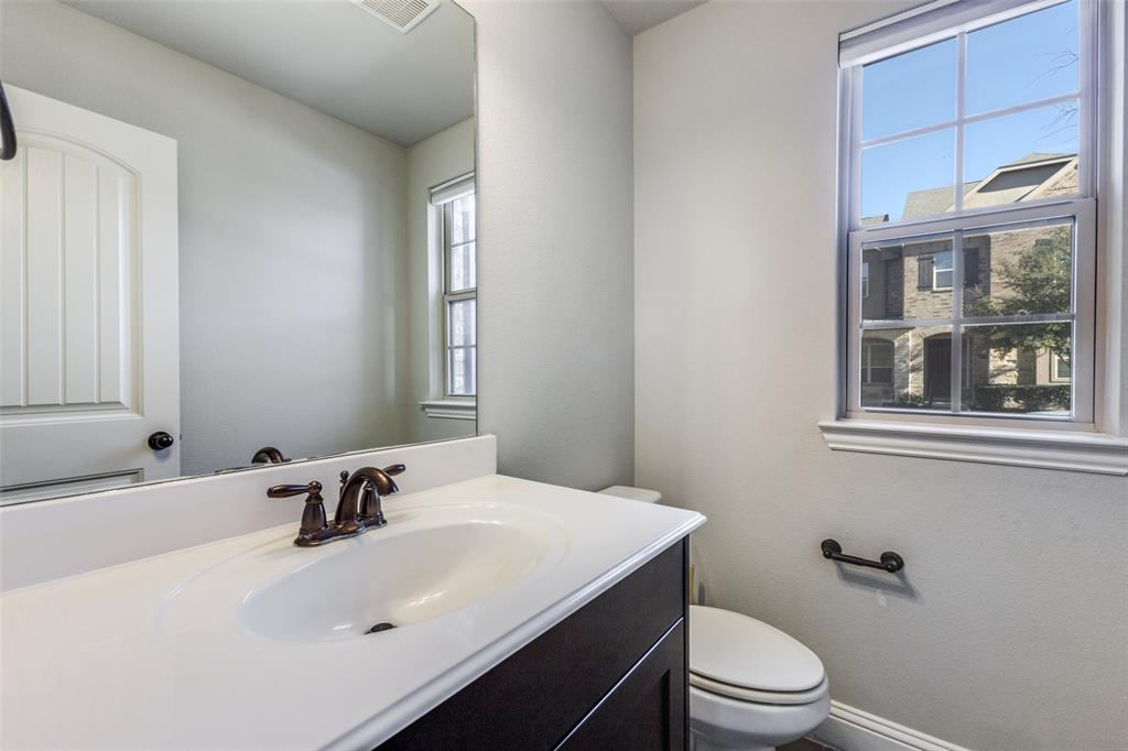 828 Rohan Drive Richardson, TX 75081 - Photo 14 of 25 a bathroom with a sink toilet a mirror and shower
