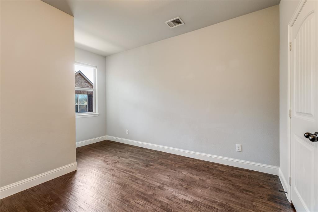828 Rohan Drive Richardson, TX 75081 - Photo 16 of 25 an empty room with wooden floor and windows