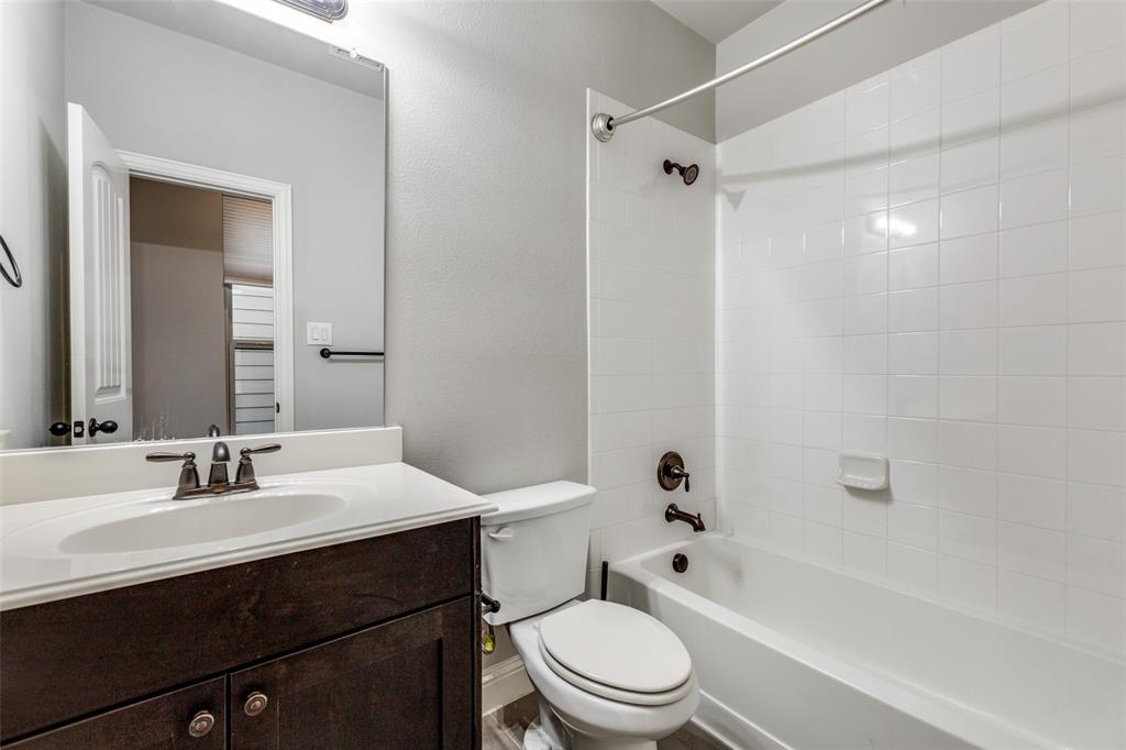 828 Rohan Drive Richardson, TX 75081 - Photo 17 of 25 a bathroom with a sink a toilet and shower