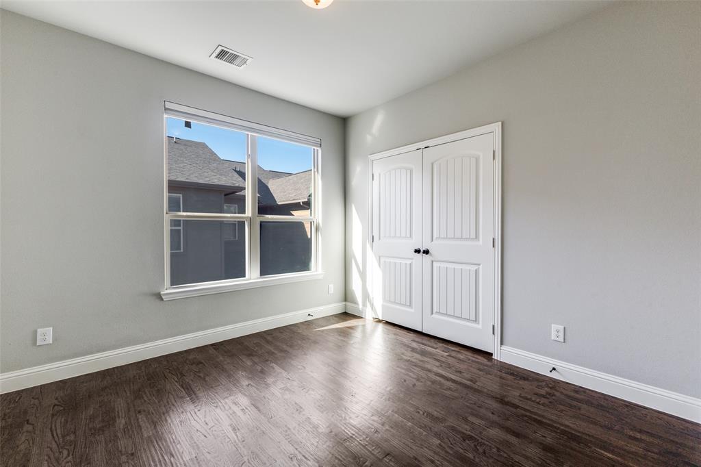 828 Rohan Drive Richardson, TX 75081 - Photo 18 of 25 an empty room with wooden floor and windows