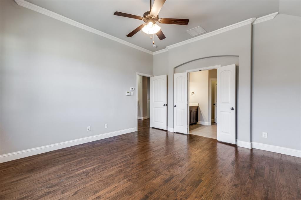828 Rohan Drive Richardson, TX 75081 - Photo 20 of 25 a view of a room with wooden floor and a ceiling fan