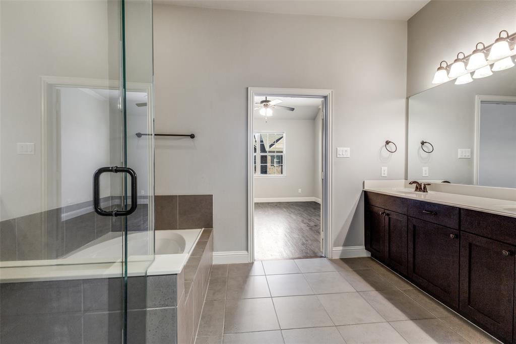 828 Rohan Drive Richardson, TX 75081 - Photo 22 of 25 a spacious bathroom with a double vanity sink and a mirror