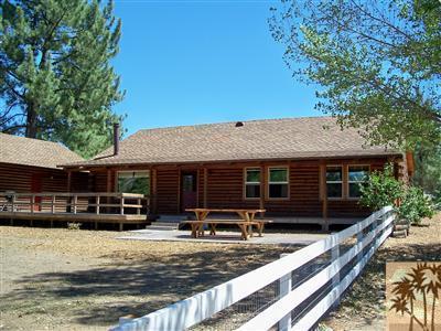 60944 Devils Ladder Road Mountain Center, CA 92561 - Photo 4 of 8 a view of a house with wooden deck and a backyard