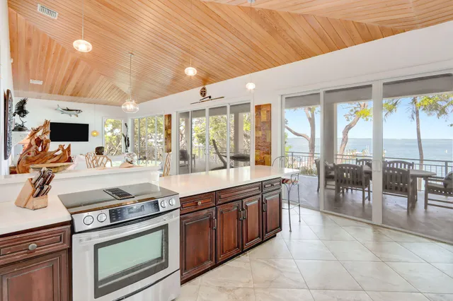 a large kitchen with stainless steel appliances granite countertop a stove and cabinets