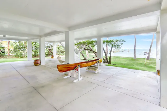 a living room with patio furniture and a floor to ceiling window