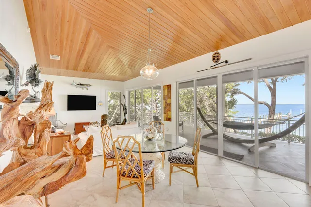 a living room with patio furniture and a wooden floor