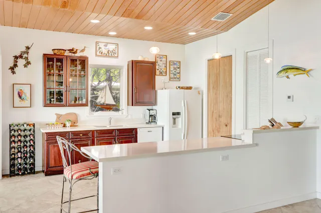 a view of kitchen with furniture and refrigerator