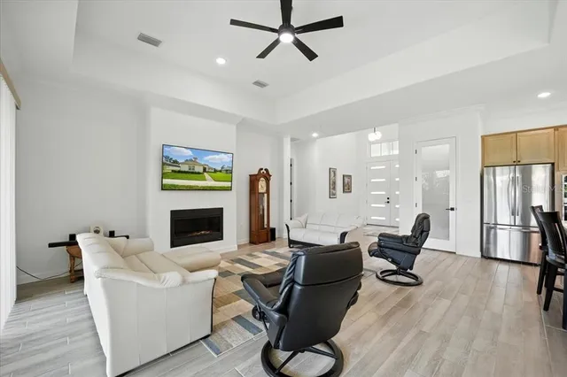 a living room with furniture a chandelier and a chandelier