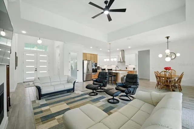 a dining room with furniture wooden floor and a floor to ceiling window