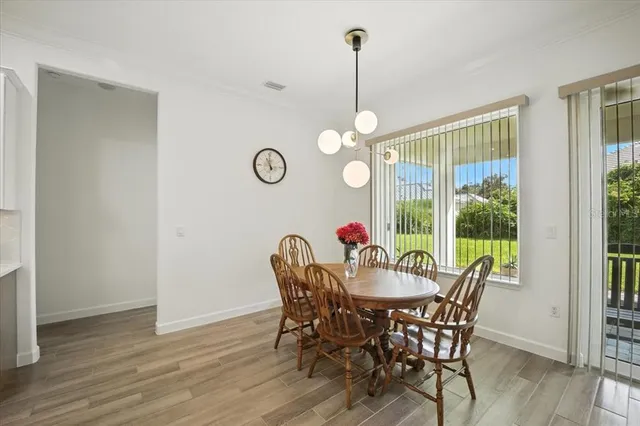 a kitchen with stainless steel appliances granite countertop a sink a stove a refrigerator and island with wooden floor