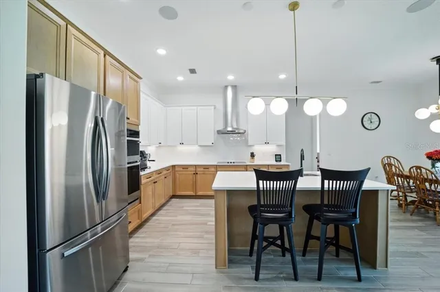 a kitchen with a sink a counter space appliances and cabinets