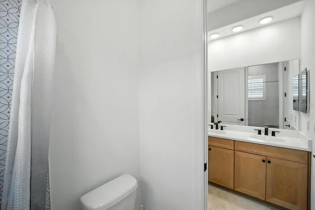 a bedroom with a bed and a mirror