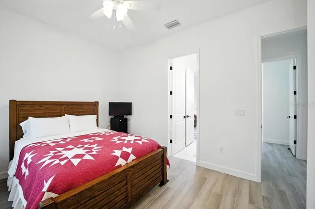 a bedroom with a large bed and a window