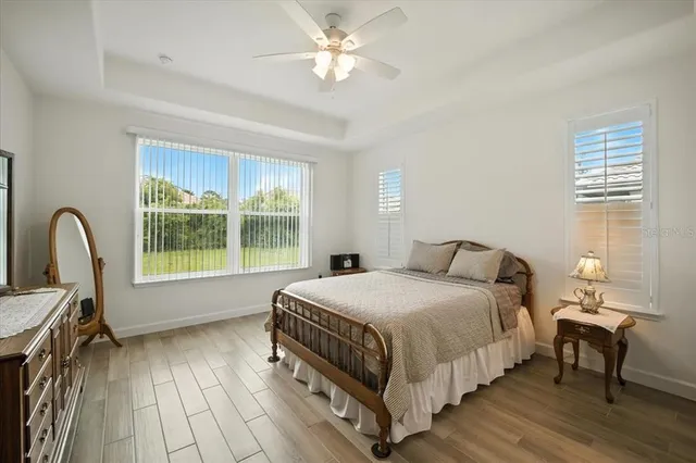 a bedroom with a bed and a flat tv screen on dresser