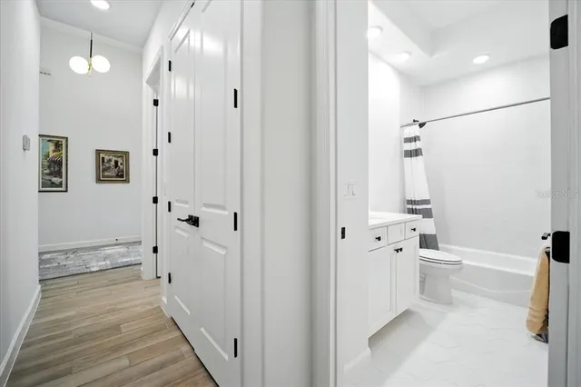 a view of a room with wooden floor