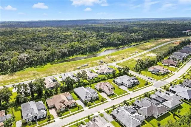 a aerial view of a house next to a big yard