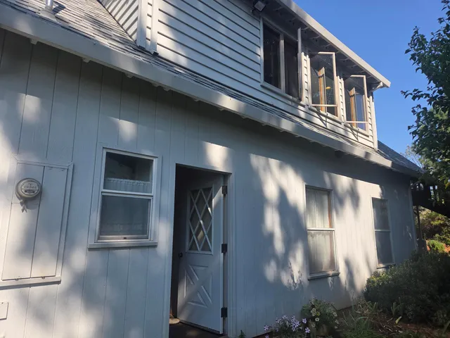 a view of a porch with furniture and a yard